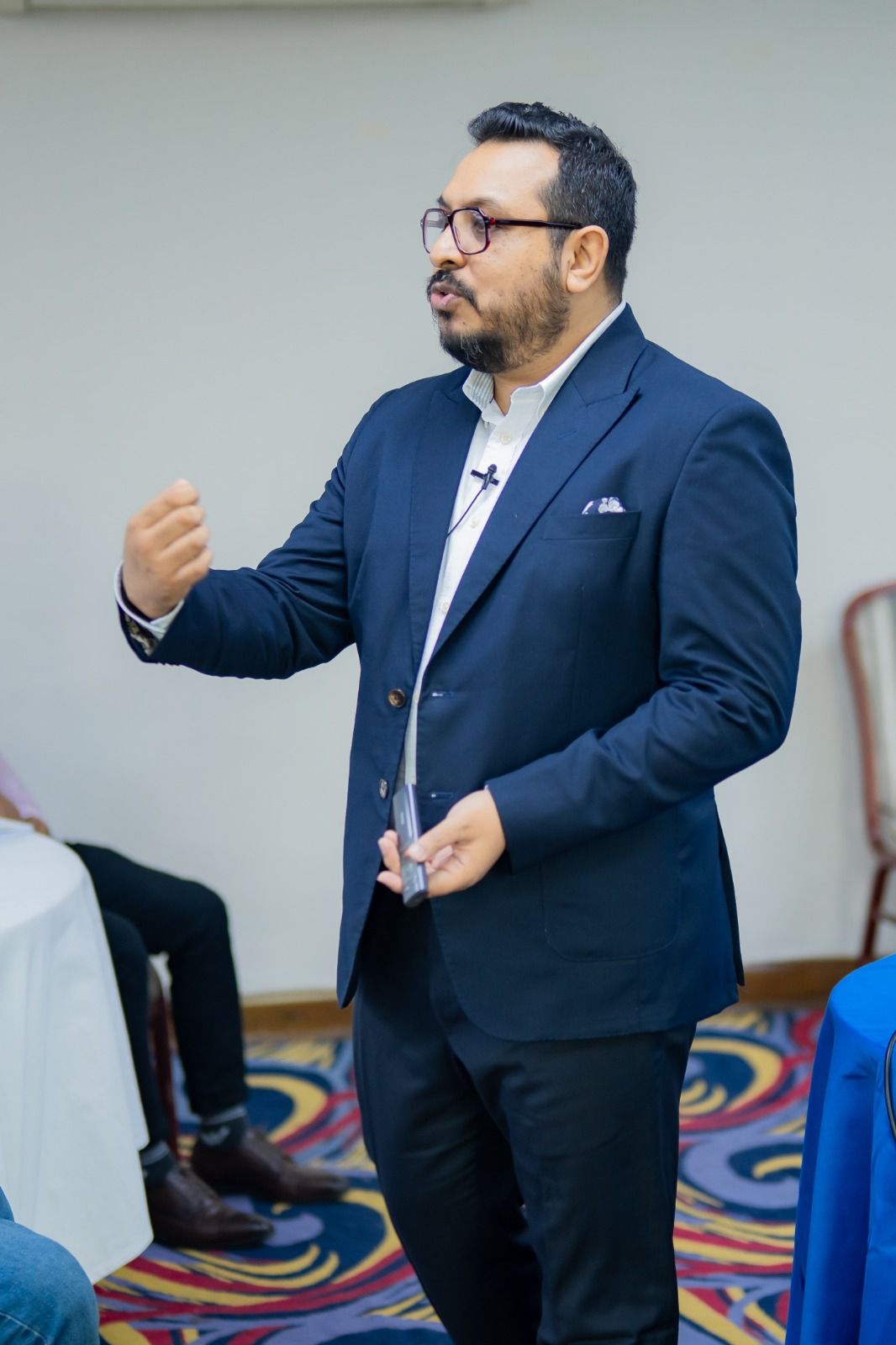 A facilitator explaining a concept to a seated group